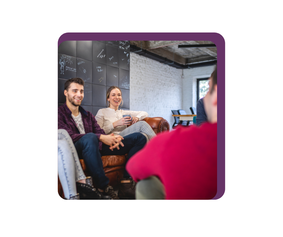 Man and woman sitting on sofa smiling