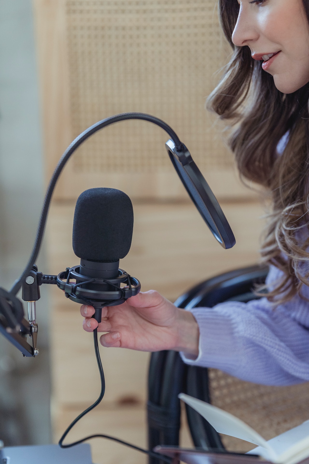 Woman with brown hair holding microphone