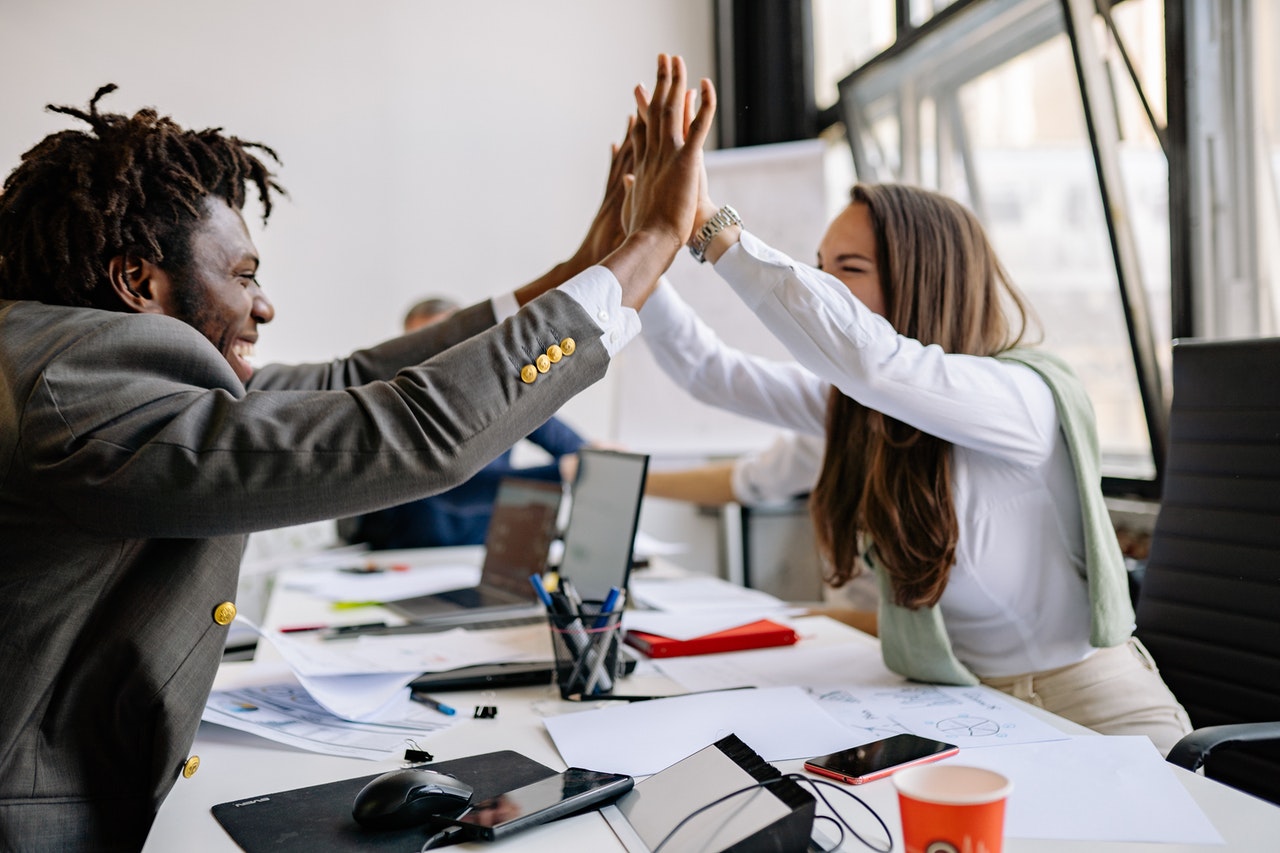 man and woman high fiving each other